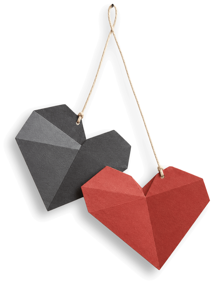 Two folded paper hearts, one charcoal and one red, hanging together on a single string